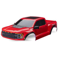 Karosszéria Traxxas Ford F-150 Raptor R piros, komplett. Beleértve a hűtőrácsot, a hátsó csomagtartó panelt, az oldalsó tükröket, az ablakmaszkot és a matrica lapot. A Traxxas TRA10124 és TRA10125 klipsz nélküli rögzítő rendszerekre történő felszereléshez tervezték. Nem a Slash modellekhez készült.