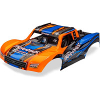 1:12-es Traxxas (Mini Slash) RC autómodellek alkatrésze: narancssárga Mini Slash karosszéria. Kész, festett és összeszerelt karosszéria, beleértve a beépített vezetőfülkét és a rögzítőkonzolt.